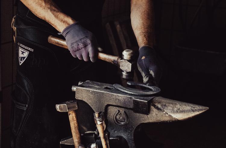 Farrier Preparing Horse Shoe