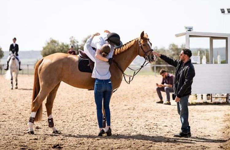 Competition-Rider-On-Horse-Celebrating-With-Hug